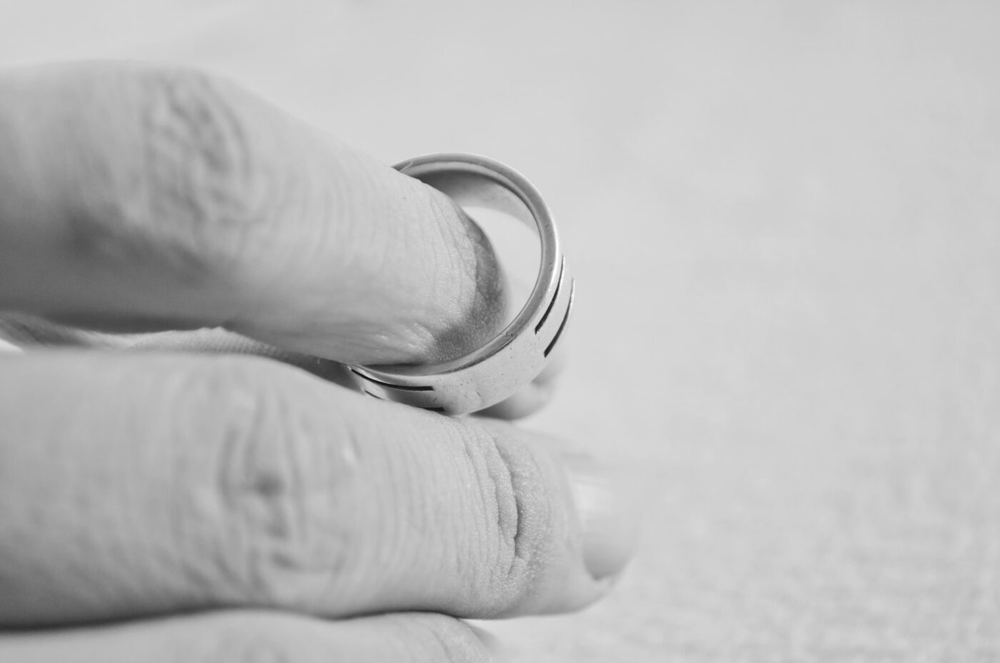 man holding ring contemplating divorce